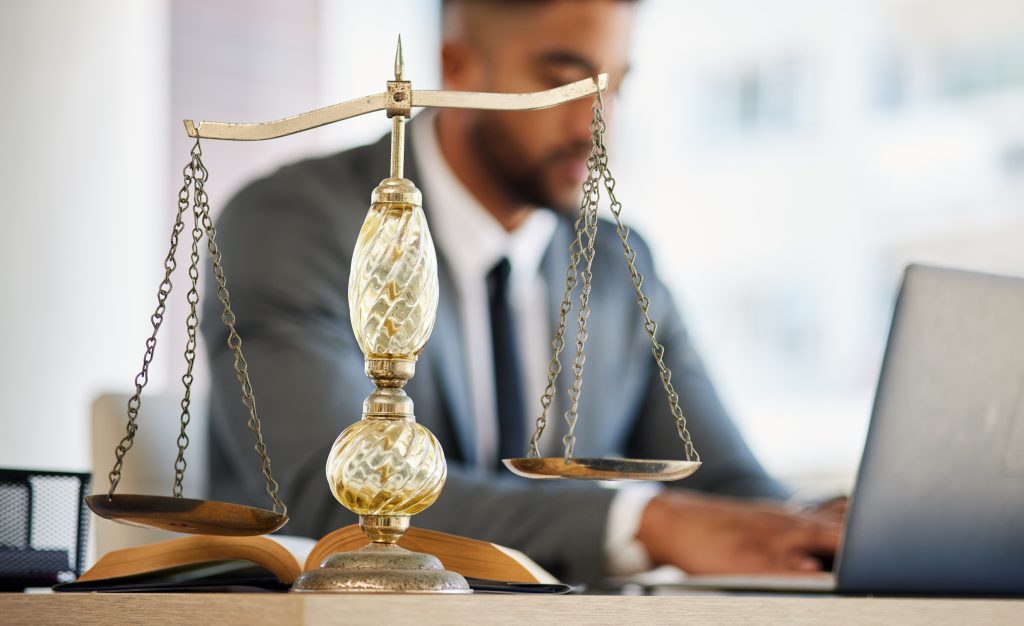 lawyer man and laptop with balance scale in offic 2023 11 27 05 32 10 utc 1024x626 1
